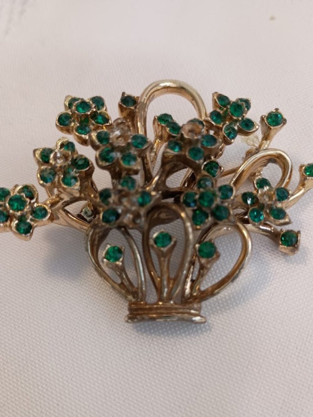 Vintage Floral Brooch with Green Rhinestones and a Gold-Tone Setting